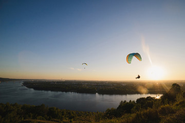 Paragliding in the sky over the river
