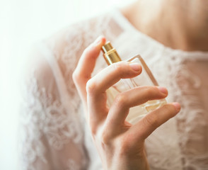 Bride applying perfume closeup