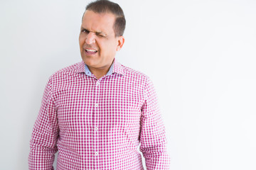 Middle age man wearing business shirt over white wall winking looking at the camera with sexy expression, cheerful and happy face.