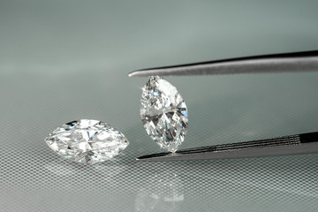 Marquise diamonds with tweezer on reflection platform