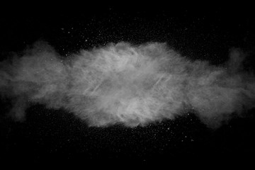 Explosion of white dust on black background.