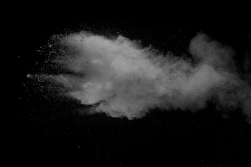 Explosion of white dust on black background.