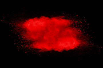 Explosion of red dust on black background.