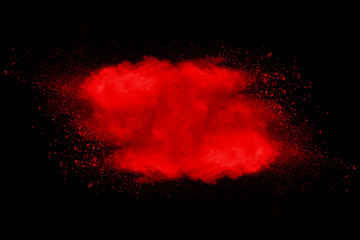 Explosion of red dust on black background.