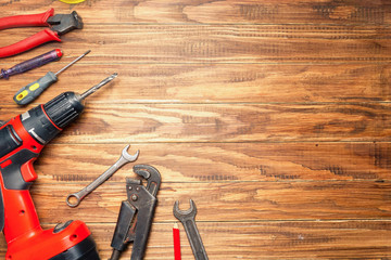 different construction tools on wooden background with copy space. diy construction tools on the...