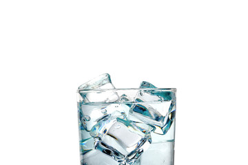 Close-up on a white background, a glass of water and ice cubes.