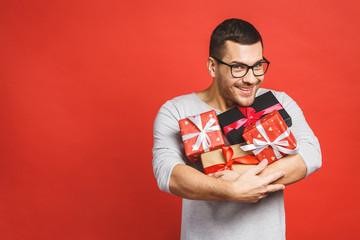 Happy holiday, my congredulations! Portrait of an attractive casual man giving present box and...