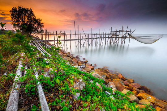 Langgai is made of bamboo and wood  at Parit Jabar , Batu  Pahat , Malaysia with  beautiful  sunset as background. Soft focus, noise and grain due long exposure.