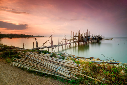 Langgai is made of bamboo and wood  at Parit Jabar , Batu  Pahat , Malaysia with  beautiful  sunset as background. Soft focus, noise and grain due long exposure.