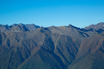 Naklejka na ściany i meble The ridges of the Caucasus Mountains. Mountains on the horizon.