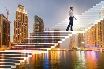 Businessman climbing career ladder over city