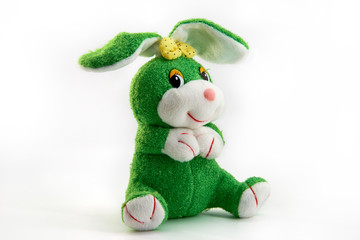 Soft toy green Bunny with yellow bow  sitting isolated on white background
