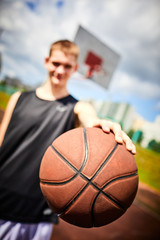 male playing basketball outdoor