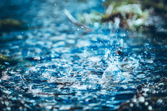 Abstract blurred water splash texture on blue background for freshness concept © Raimonds Kalva