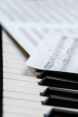 Music book on the piano keys. Selective focus.