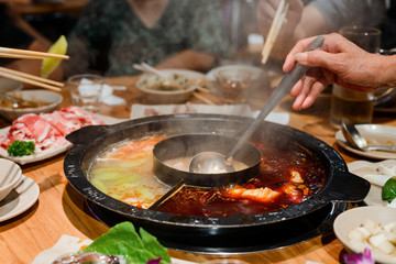 Woman taking food from pot