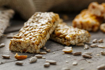 Casinac from sunflower seeds on old vintage background with burlap cloth. Country style. Delicious sweets from seeds of sunflower, sesame and peanuts, covered with shiny glaze