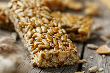 Casinac from sunflower seeds on old vintage background with burlap cloth. Country style. Delicious sweets from seeds of sunflower, sesame and peanuts, covered with shiny glaze