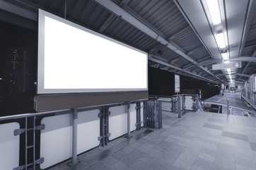large blank advertise billboard white LED screen horizontal for design banner announcement exit way at outdoor public sky train platform station.