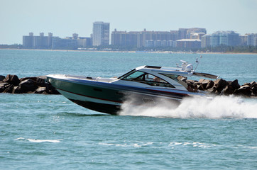High-end cabin cruiser speeding towards Biscayne Bay on Government Cut in Miami Florida