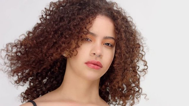 slow motion from 60 fps hair blowing closeup portrait of mixed race model with freckles