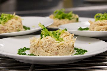 fish dish with spinach on a white plate