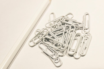 White paperclips and pencil