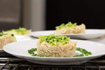 fish dish with spinach on a white plate