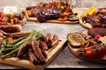 Assorted delicious grilled meat with vegetable on rustic table