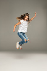 Fototapeta na wymiar Happy jumping young girl