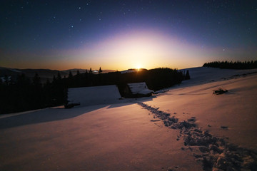 A charming moonlit night in the Ukrainian Carpathian Mountains with the moonlight and millions of...