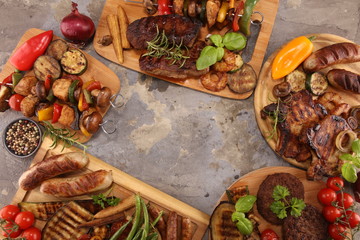 Assorted delicious grilled meat with vegetable on rustic table