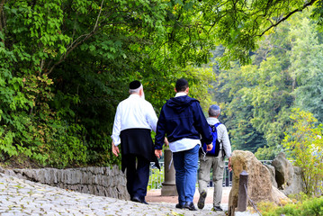 Uman, Ukraine. Older people , a Hasidic Jews family  walk in the Sofia park during the Jewish New...