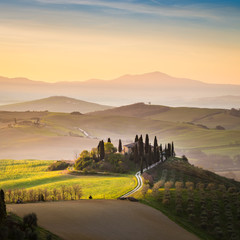 A lonely farmhouse between tuscan rolling hills. Val d'Orcia, Siena province, Tuscany, Italy