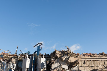 Ruined part of the wall in the blue sky