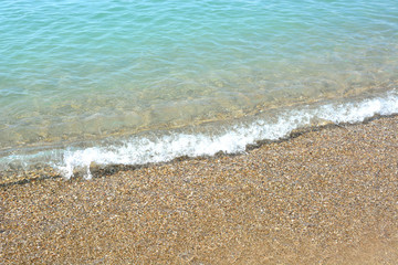 Fototapeta na wymiar Sea wave in the sand, White sand on the beach with turquoise water in Djerba, Tunisia