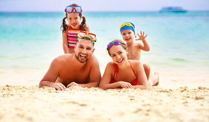 happy family father, mother and children on  beach at sea