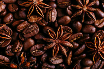 Star anise and coffee beans on the kitchen table. Fragrant spices for coffee drink, closeup background.
