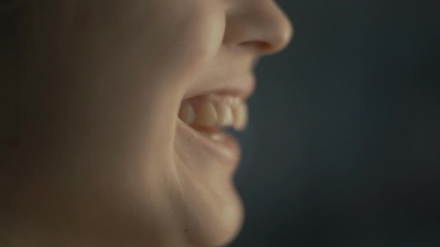 lips young woman talks at home with a friend at the window, part of the face is a girl smiling, concept of health and friendship