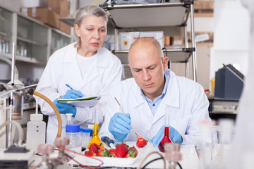 Biochemists recording experimental procedure and results