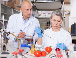 Biochemists recording experimental procedure and results
