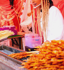 African American woman prepares food at the stake