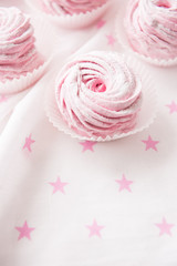 Obraz na płótnie Canvas Some pink marshmallow curl on white background