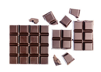 Chopped chocolate cubes, bitter, dark chocolate bar isolated on white background, top view