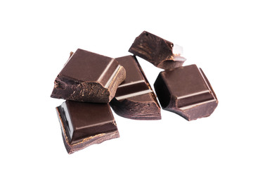 Chopped chocolate cubes, pieces of dark chocolate isolated on white background