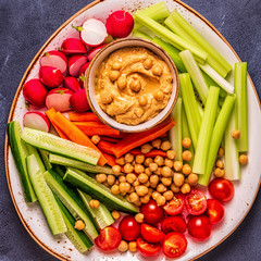 Hummus with various fresh raw vegetables.
