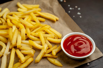 French fries with ketchup on concrete background