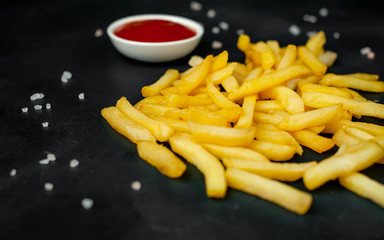 French fries with ketchup on concrete background