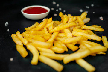 French fries with ketchup on concrete background