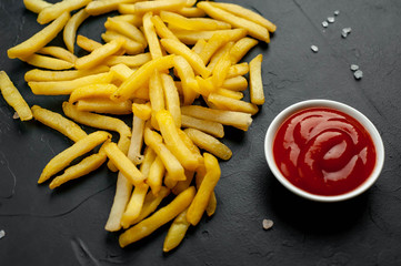 French fries with ketchup on concrete background